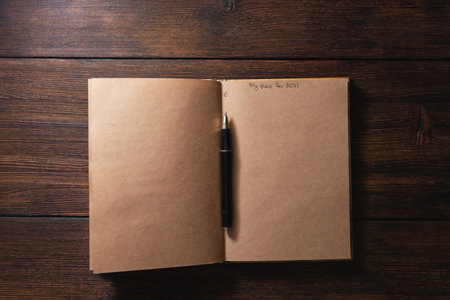Notepad with the inscription on the page My plans for 2021 with a pen