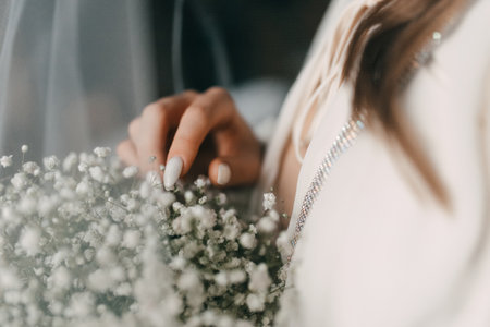 woman bride in wedding dress holding white bouquet in handの写真素材