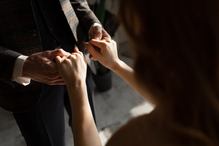 Close-up of a man in a suit holding a girls hands.の写真素材