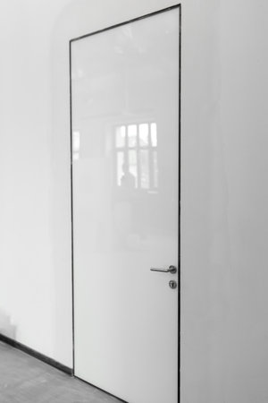 white glossy door on white office wallの写真素材