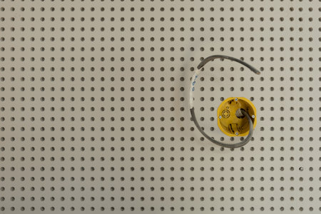 installation of a socket with wiring a wall made of perforated plasterboardの写真素材