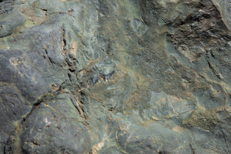 Texture of alien green-yellow stone in soft light