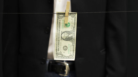 Dollar on clothesline as sign of money laundering.