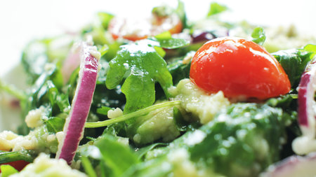 Rucola salad with tomatoes, avocado and onion.の写真素材