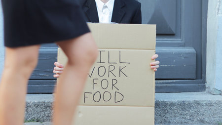Businessman outdoors with will look for food sign.の写真素材