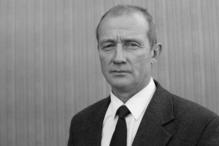Portrait of a senior businessman in front of building wall.