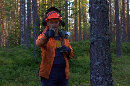Lumberjack smiling into the camera and showing thumbs up middle shot.