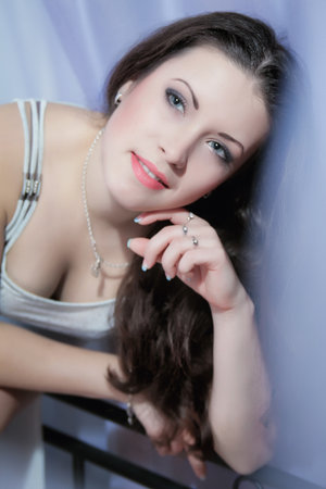 Fashion portrait of young elegant woman in bedの写真素材