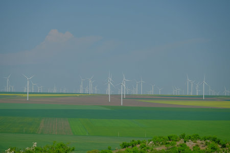 Field with wind turbines to produce green energyの写真素材