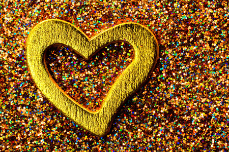 Gold shiny heart against the background of tinselの写真素材