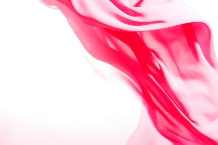 Pink fabric winds waves, creating a beautiful background of the foldsの写真素材