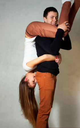 A young man holding his girlfriend on handsの写真素材