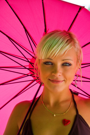 Portrait of a young pretty girl with umbrellaの写真素材