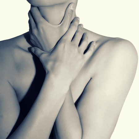 Hands strangle a female slender neck. Girl pants, lack of air.の写真素材