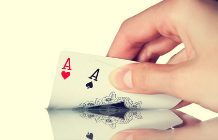 The man handed out a pocket pair of aces in Texas pokerの写真素材
