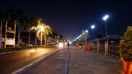 Beautiful at night in the city Beside the road there are trees and lightsの写真素材