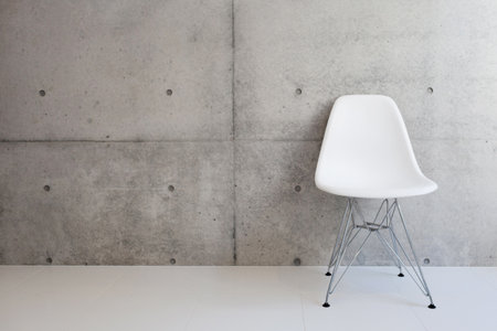 white chair and concrete wall の写真素材