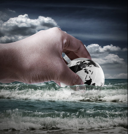 holding a glowing earth globe in his hands の写真素材