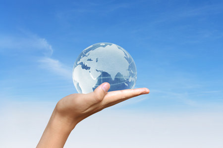 glowing earth globe in his hands の写真素材