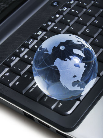 globe on a laptop keyboard の写真素材