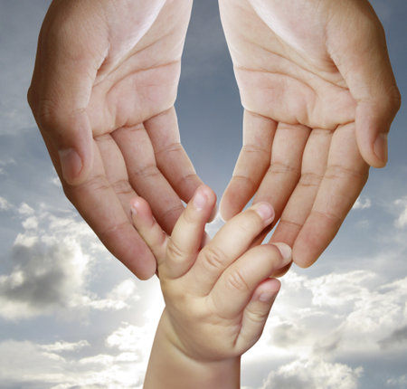 father giving hand to a child の写真素材