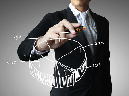 Male hand drawing a graph の写真素材