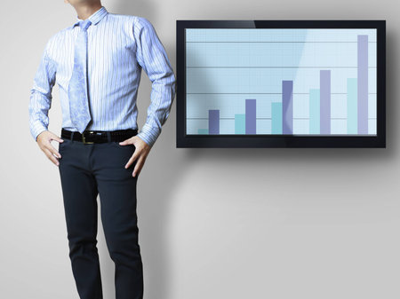 young businesspeople front of a huge plasma TV screen の写真素材