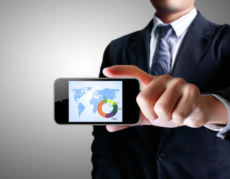 Touch screen mobile phone in a handsの写真素材