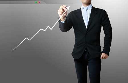 business men drawing a graph in whiteboardの写真素材