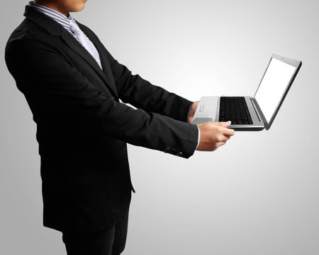 man with laptop in his handsの写真素材