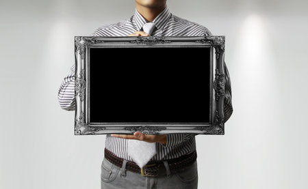 Businessman hand holding a frame 