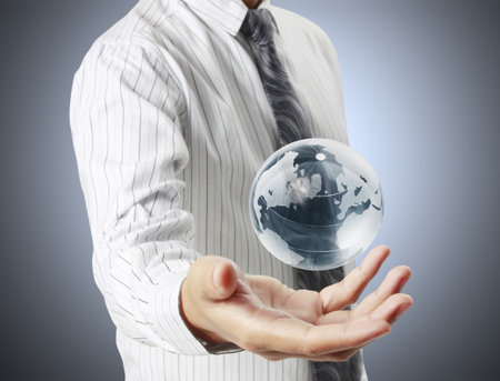 holding a glowing earth globe in his hands の写真素材