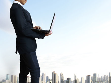 business man holding his laptopの写真素材