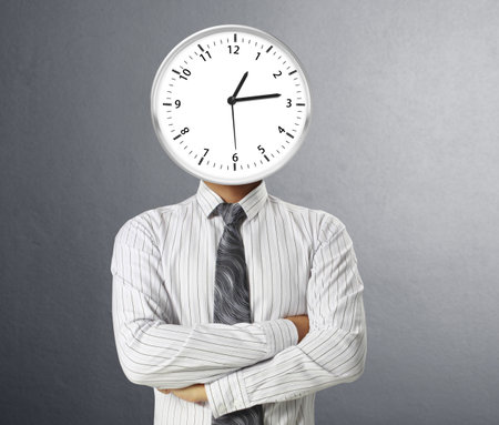 Businessman with alarm clock on heaの写真素材