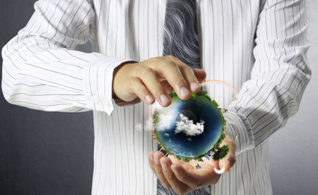 holding a glowing earth globe in his hands の写真素材