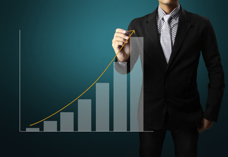 Business man hand drawing a graph の写真素材