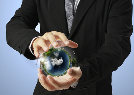 holding a glowing earth globe in his hands の写真素材