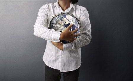 holding a glowing earth globe in his hands の写真素材