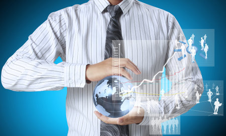 holding glowing earth globe and  financial symbols coming from hand の写真素材