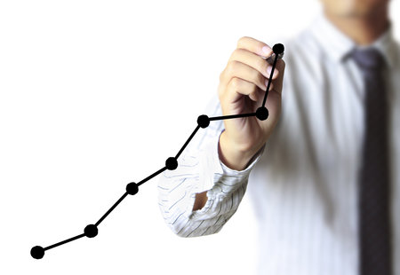 Business man hand drawing a graph の写真素材