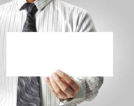 Business man handing a blank business card over の写真素材