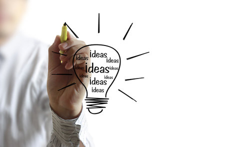 Business man drawing light bulb の写真素材