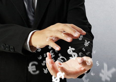 businessman with financial symbols coming from hand の写真素材
