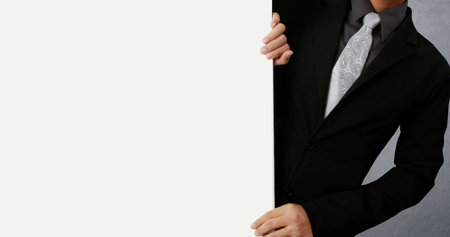 Business man handing a blank business card over の写真素材