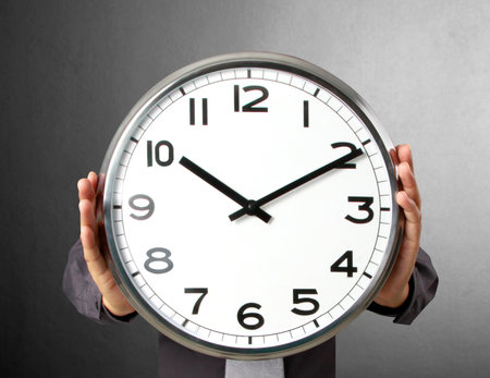 Businessman with alarm clock in handの写真素材