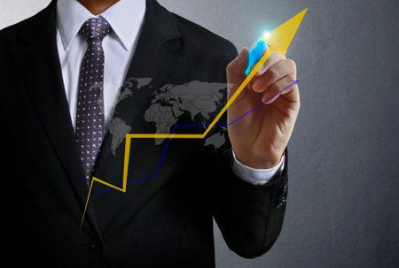 Business man hand drawing a graph の写真素材