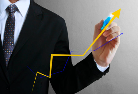 Business man hand drawing a graphの写真素材