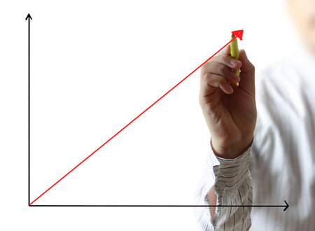 Business man hand drawing a graph の写真素材