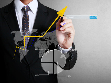 Business man hand drawing a graph の写真素材