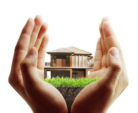 Business man house in human hands の写真素材